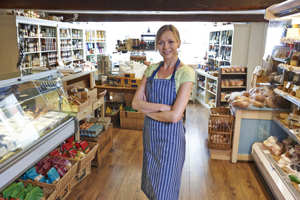 Corner shop owner standing
